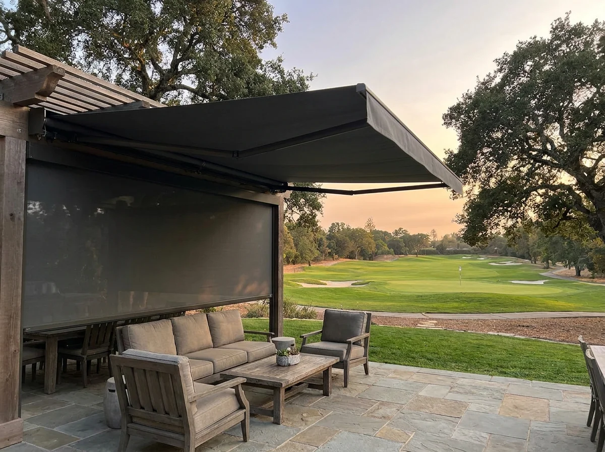 Covered patio with a folding-arm awning and zip screen shading the seating area of an Irene home, golf course beyond